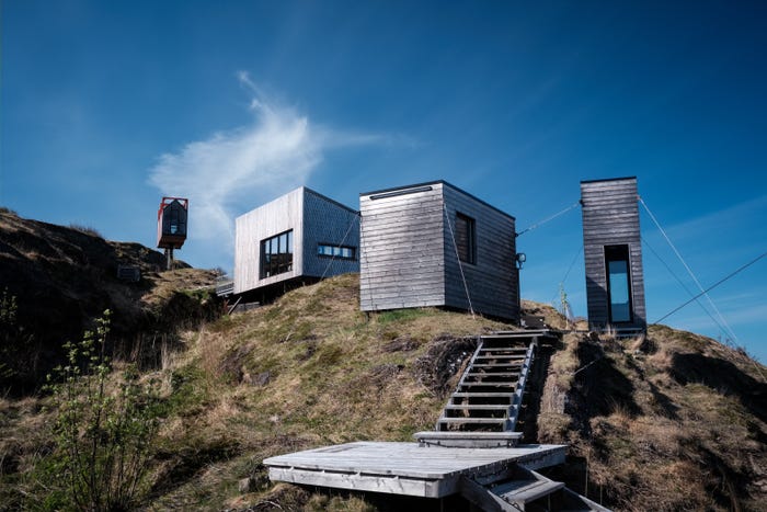 Arctic hideaway buildings on a hill